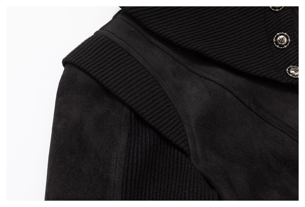 Close-up of a black garment shoulder and upper front with ribbed panels and silver-tone buttons.