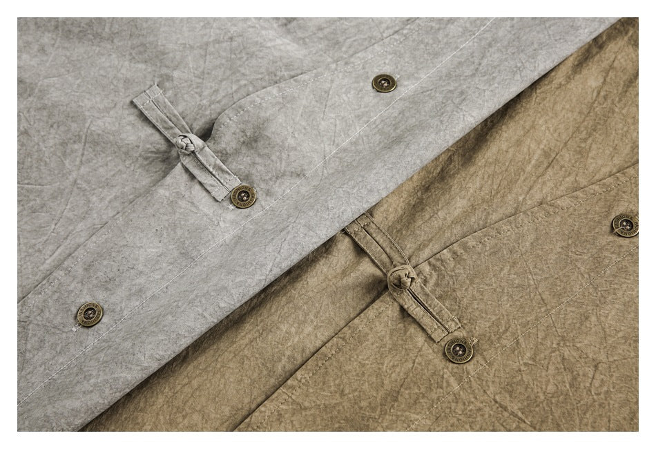 Close-up of gray and khaki-brown shirt fronts with buttons and knotted fabric-loop closures.