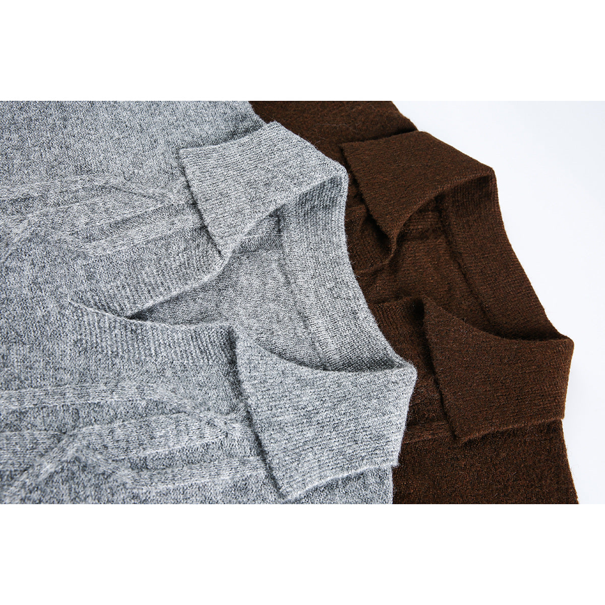 Close-up of gray and dark brown cable-knit sweaters, showing folded knit edges and texture.