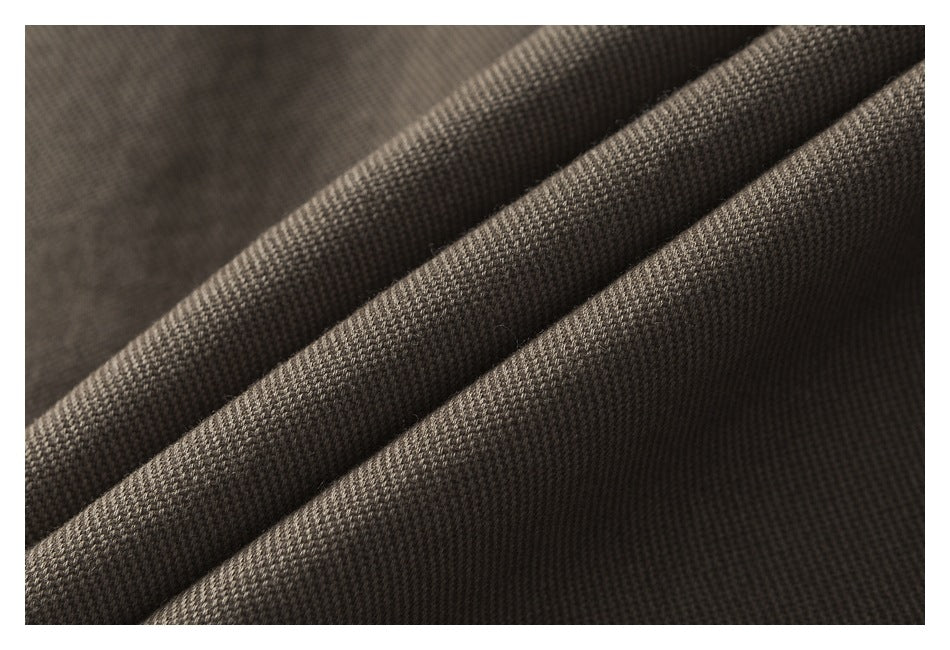 Macro view of brown-gray garment fabric folded to show its textured weave.