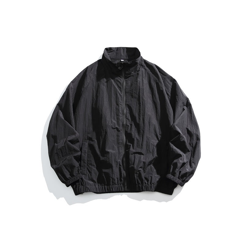 Black stand-collar zip-front jacket laid flat with elastic cuffs and hem