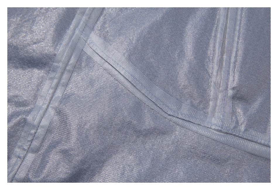 Close-up of pale gray jacket lining with stitched seams.