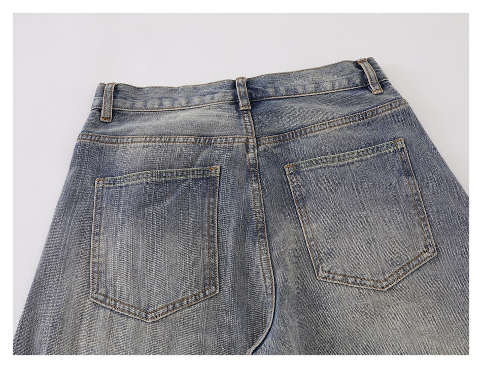 Cropped back view of faded blue jeans showing two patch pockets, belt loops, and the waistband.