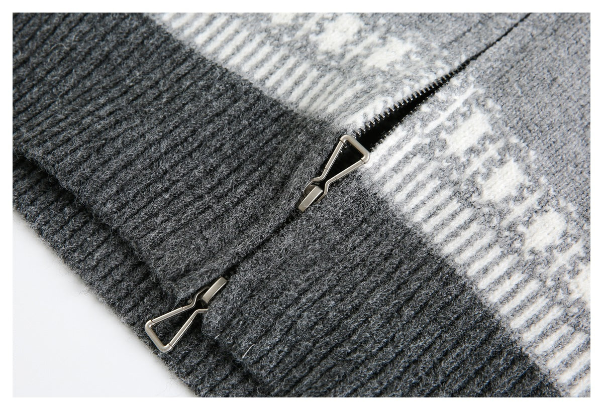 Close-up of a dark ribbed knit panel, cream geometric band, and metal zipper pulls.