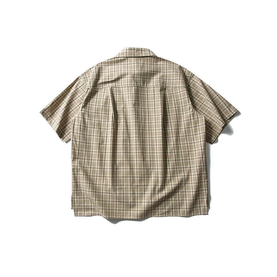 Back view of a beige plaid short-sleeve button-up shirt with a yoke and back pleat.