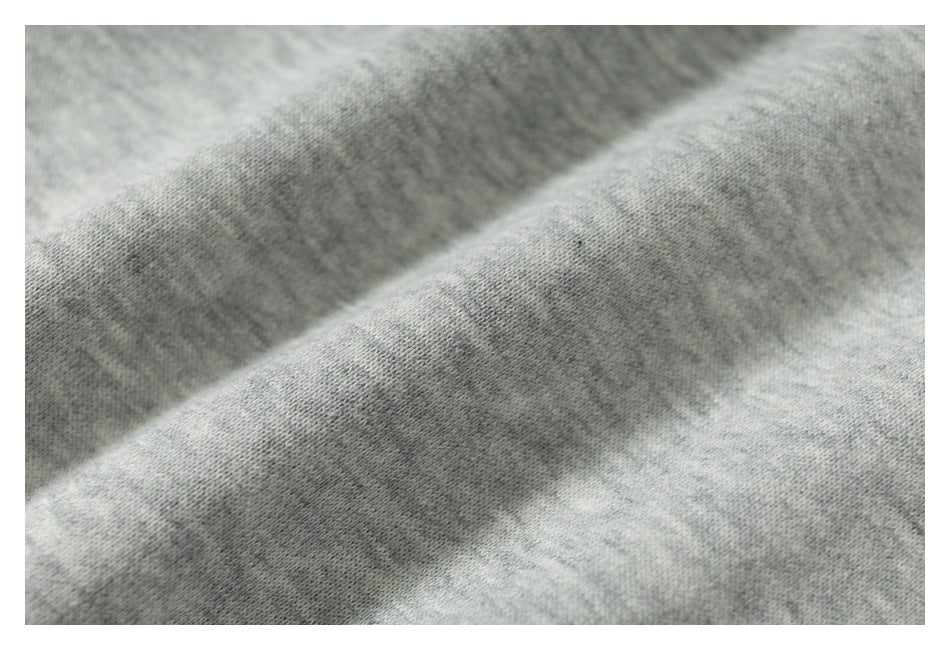 Macro view of the light gray hoodie fabric and its soft-looking surface.