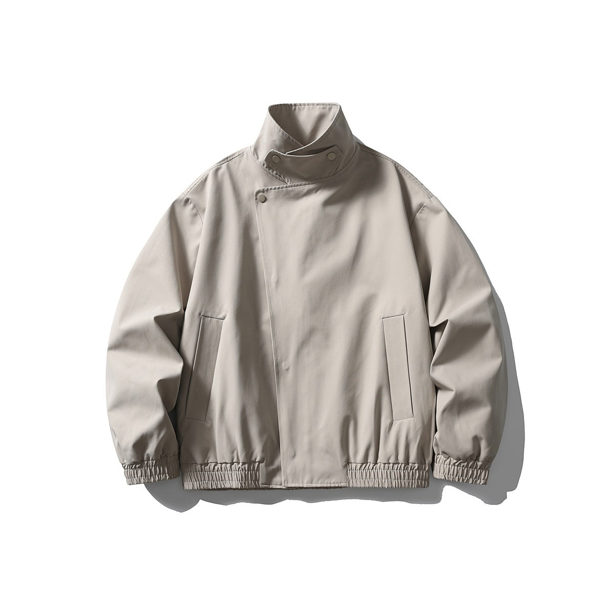 Light gray-beige stand-collar jacket with diagonal snap front, vertical pockets and elastic hem, flat lay