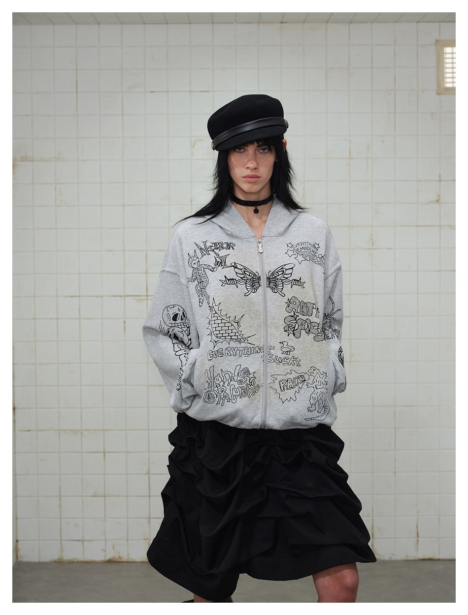 Model wearing the gray graffiti-print zip-up hoodie with hands in pockets, black cap and black ruched skirt, tiled background