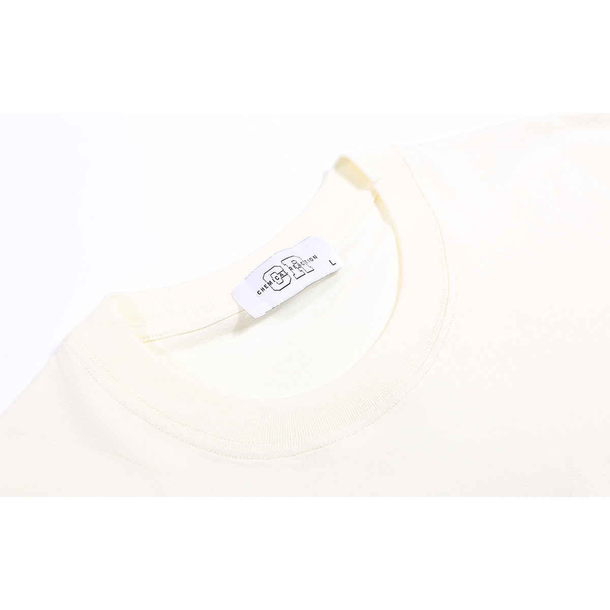 Close-up of an off-white T-shirt neckline with a ribbed crew collar and a small inner label.