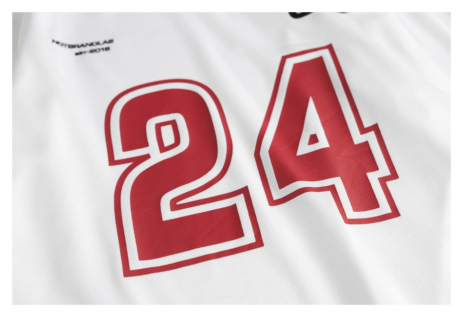 Close-up of a large red number 24 with white and red outlines on a white jersey.