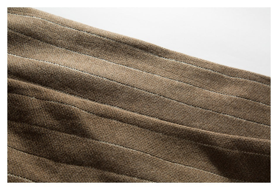Close-up showing narrow light stripes across the brown knit cardigan fabric.