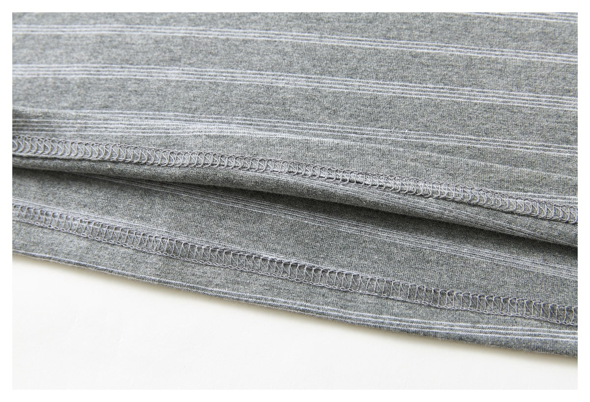 Close-up of a gray striped garment hem showing parallel rows of overlock stitching.