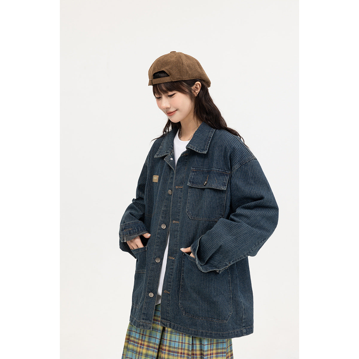 Model wearing an oversized dark blue denim jacket with a buttoned chest pocket and large lower pockets.
