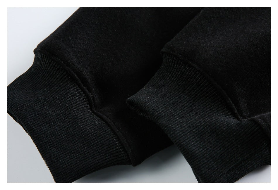 Close-up of two black ribbed cuffs with stitched sleeve seams.