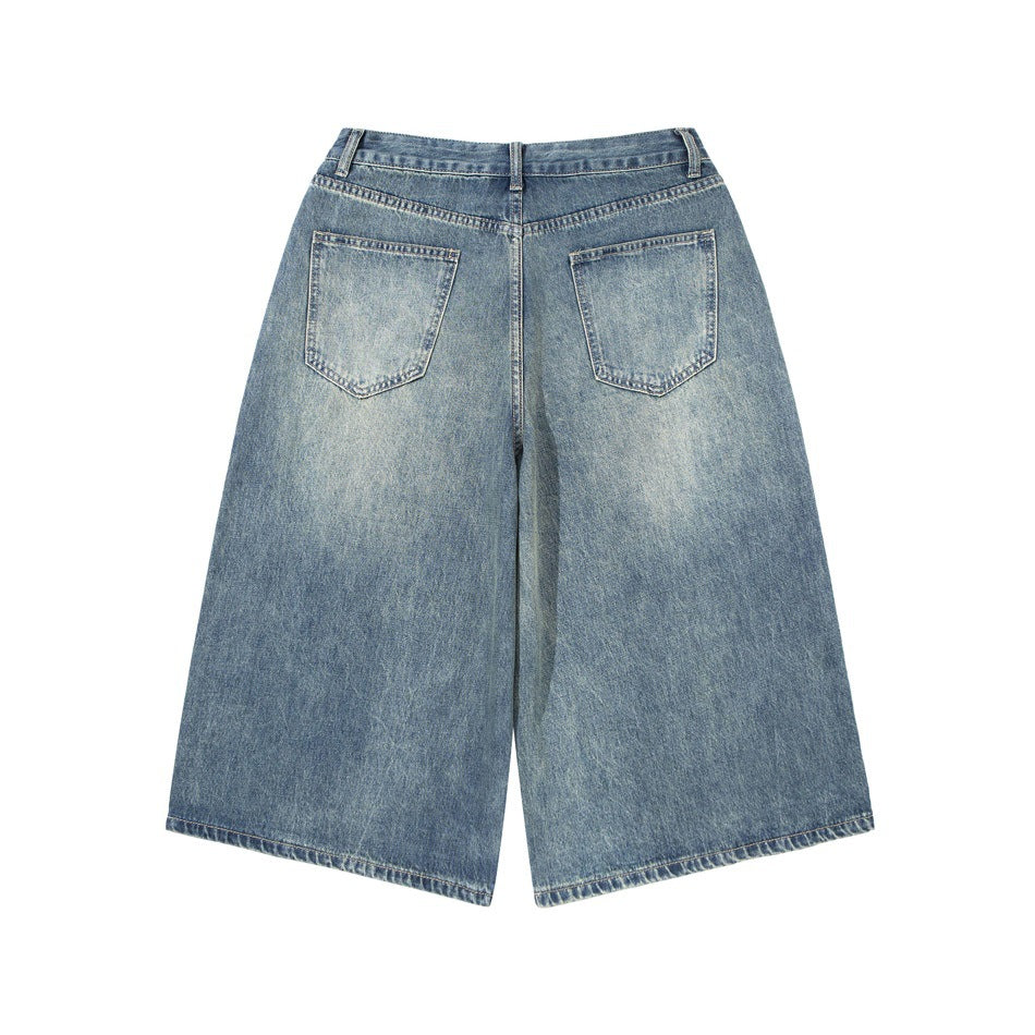 Back view of light blue wide-leg denim shorts with two rear pockets and faded wash.