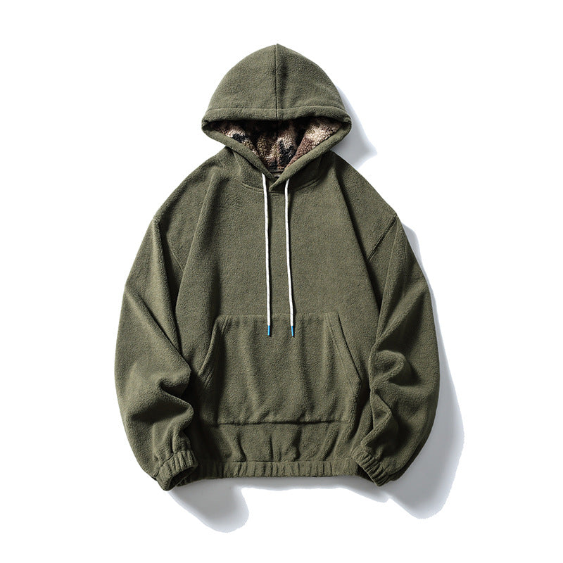 Army green fleece-like pullover hoodie with front pocket, white drawcords and camouflage plush hood lining, flat lay
