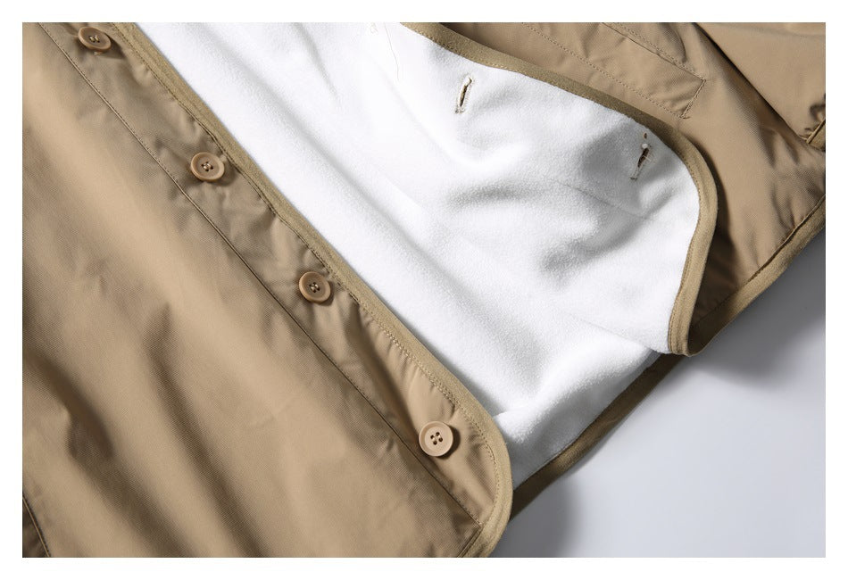 Close-up of the open tan jacket showing white lining, bound edges, and tan front buttons.