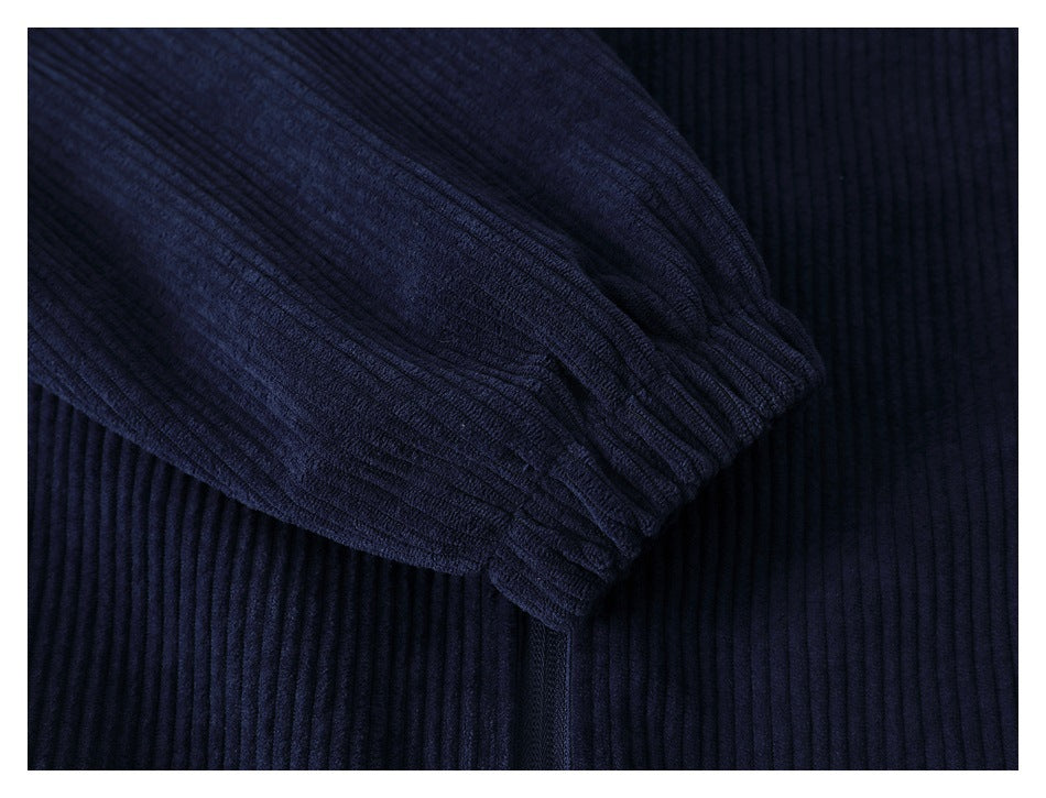 Close-up of a dark navy sleeve ending in a gathered ribbed cuff.