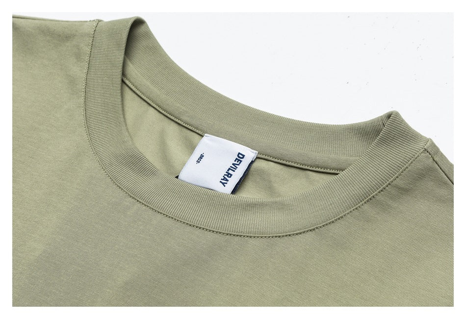 Close-up of an olive-green T-shirt neckline with ribbed crew neck trim and sewn-in label.