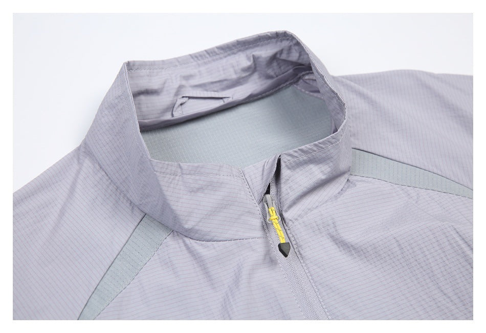 Close-up of a pale lavender jacket's stand collar and front zipper, with a yellow zipper pull and gray-green panels.