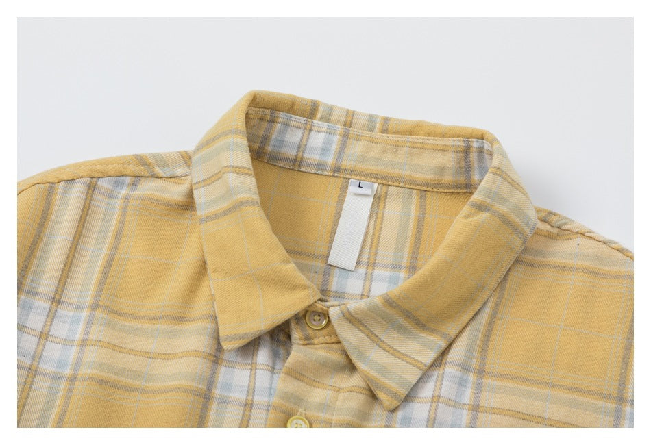 Close-up of the shirt's plaid collar, top buttons, and inner size label.