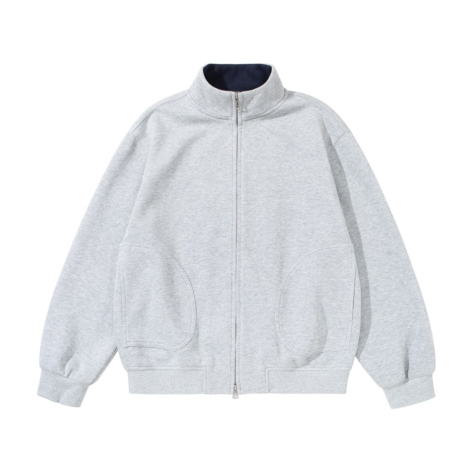 Heather gray zip-up stand-collar jacket flat lay, front view with navy collar lining and curved front pockets