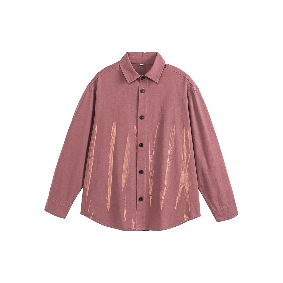 Red long-sleeve button-up shirt with orange-toned brushstroke marks on the lower front, flat lay