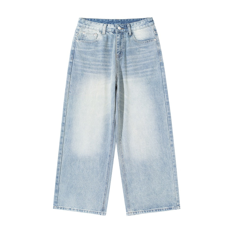 Front of light blue washed wide-leg jeans with faded thighs, whiskering, button fly and belt loops