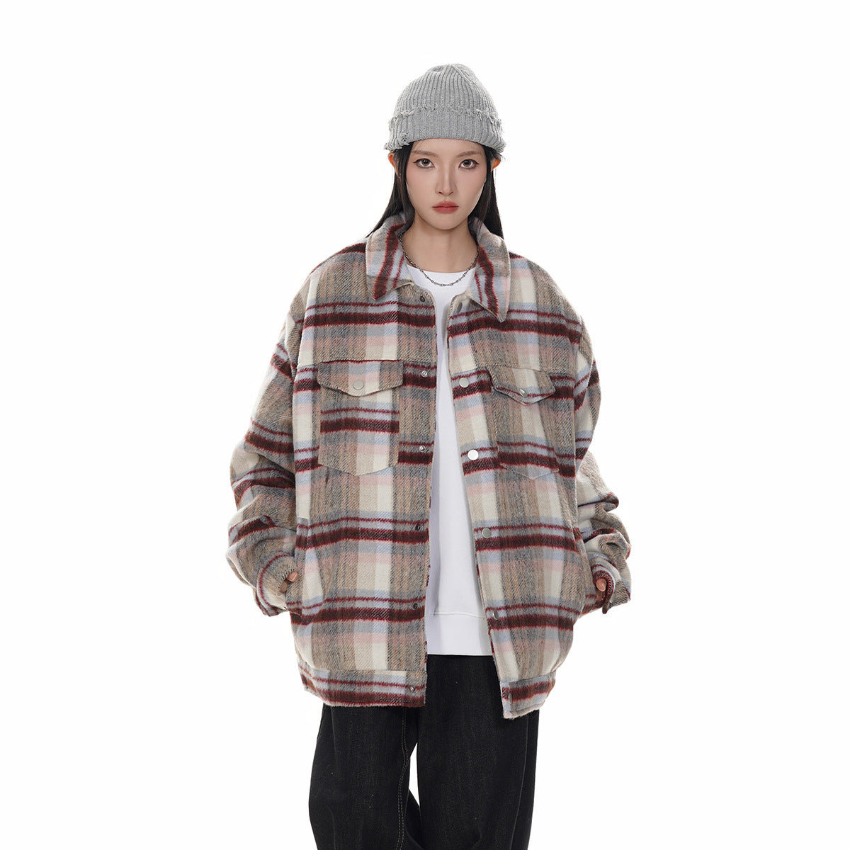 Front view of a model in a cream, gray, and red plaid button-front jacket with two flap chest pockets.