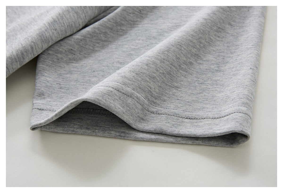 Close-up of the stitched hem on a heather gray garment.