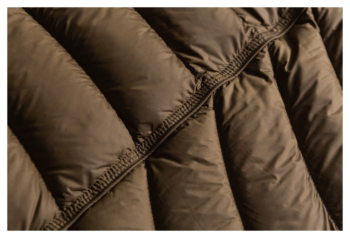 Close-up of brown padded jacket quilting and a diagonal stitched seam.