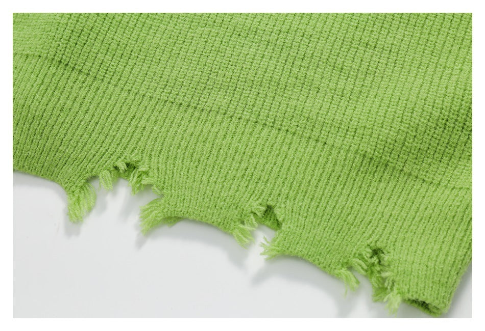 Close-up of lime green ribbed knitwear showing an intentionally frayed raw edge.