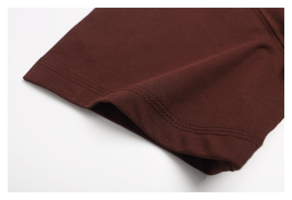 Close-up of the dark brown T-shirt sleeve hem with parallel rows of stitching.