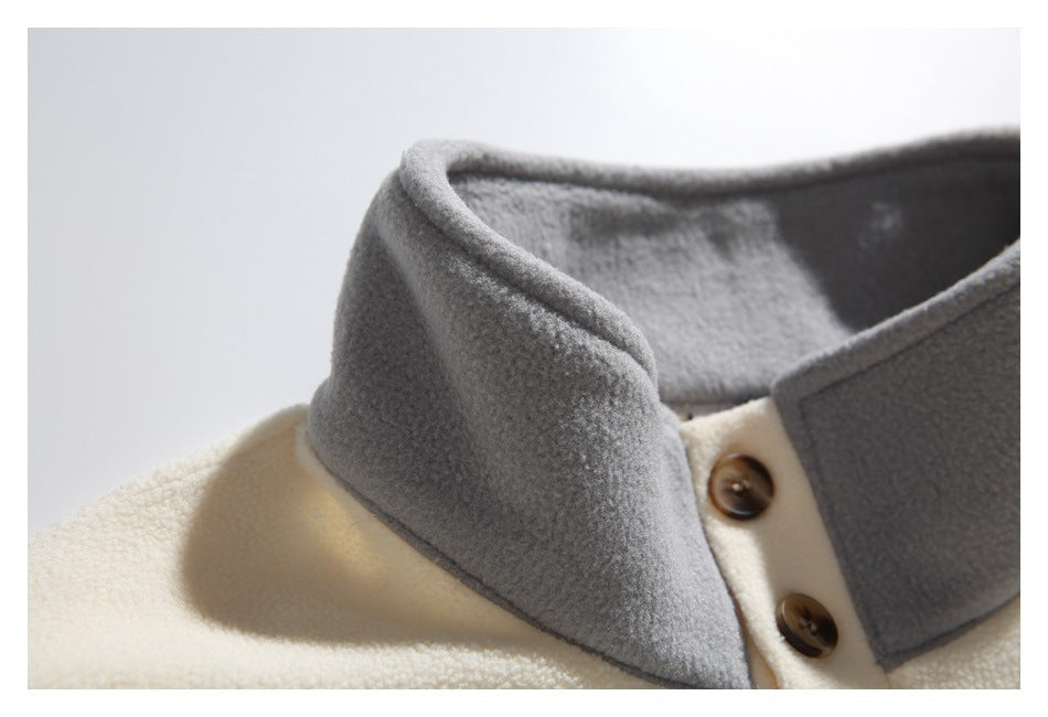 Close-up of the gray fleece collar and upper button placket on the cream pullover.
