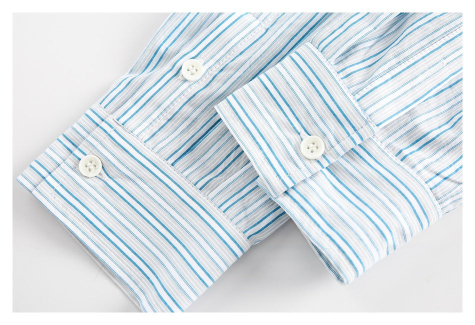 Close-up of blue-and-gray-striped shirt cuffs with white buttons.