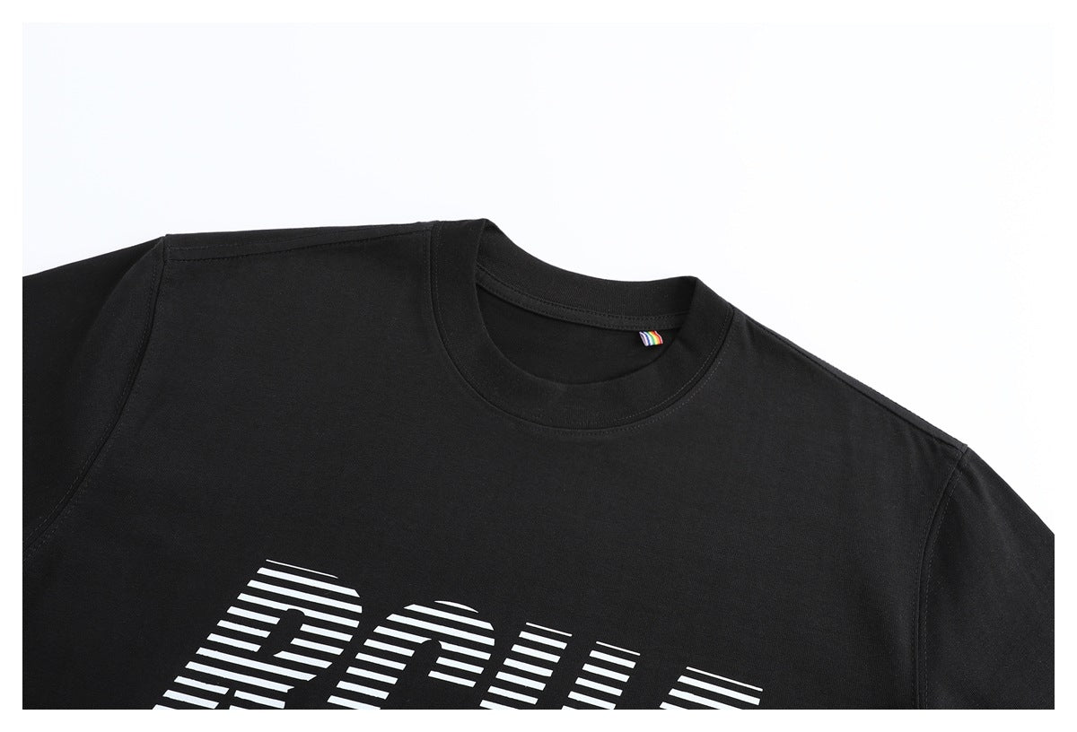 Close-up of a black crew-neck T-shirt with partial white striped lettering and a small rainbow neck tag.