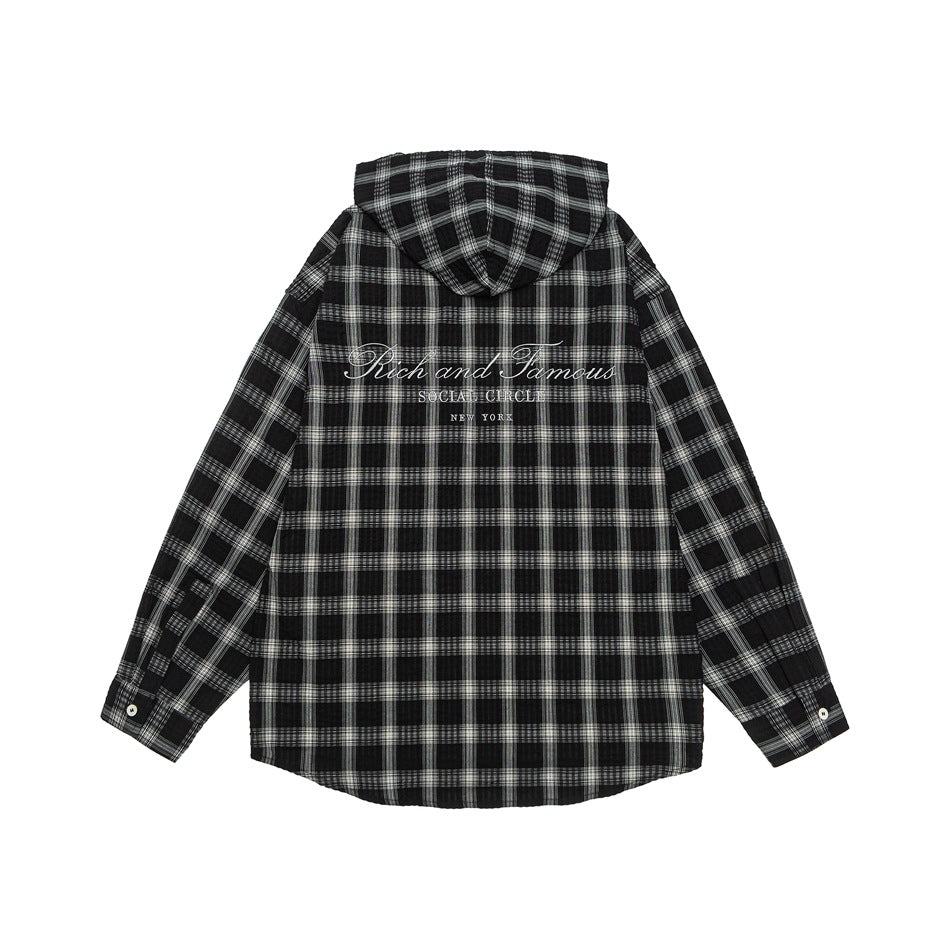 Back view of a black-and-white plaid hooded shirt with white script embroidery across the upper back.