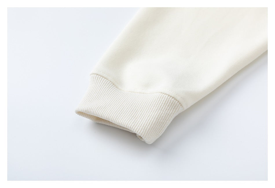 Close-up of an ivory sleeve ending in a wide ribbed cuff.