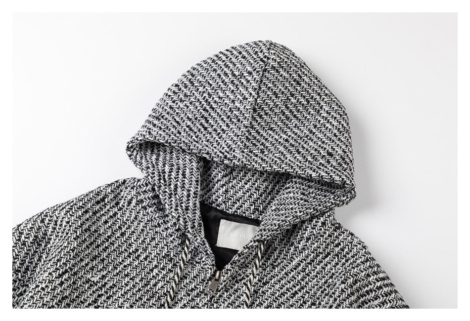 Close-up of a black-and-white patterned hood and upper chest with a front zipper.