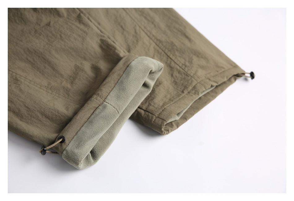 Close-up of the pants' adjustable cuff with a drawcord and a light-colored fleece-like inner surface.