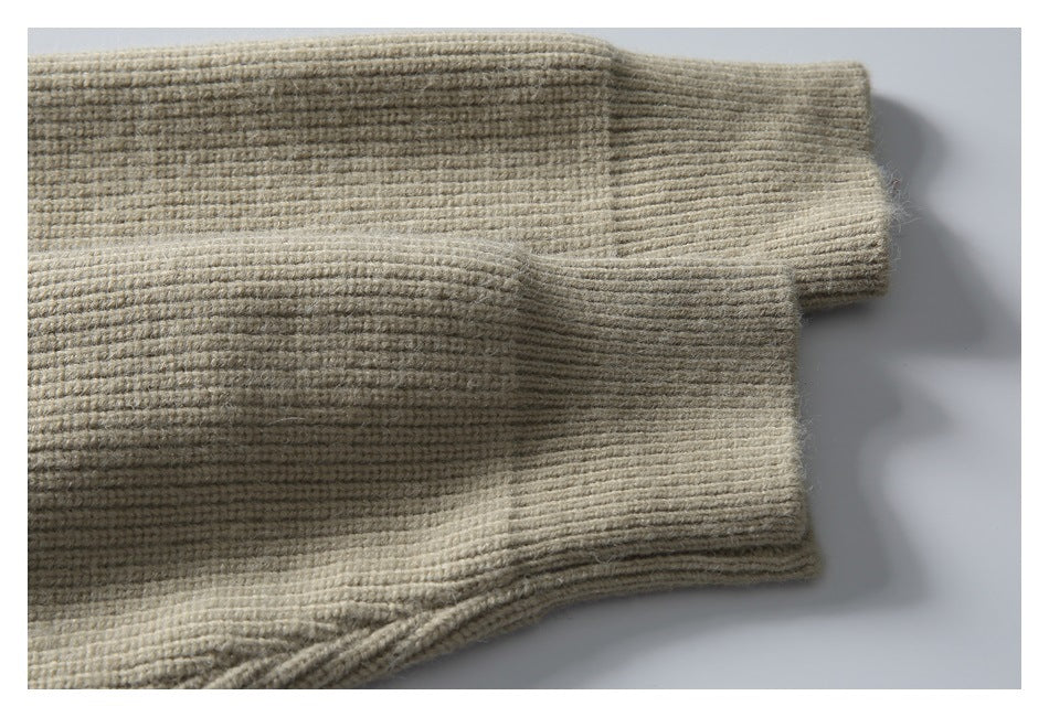 Close-up of the beige sweater’s long sleeves and wide ribbed cuffs.