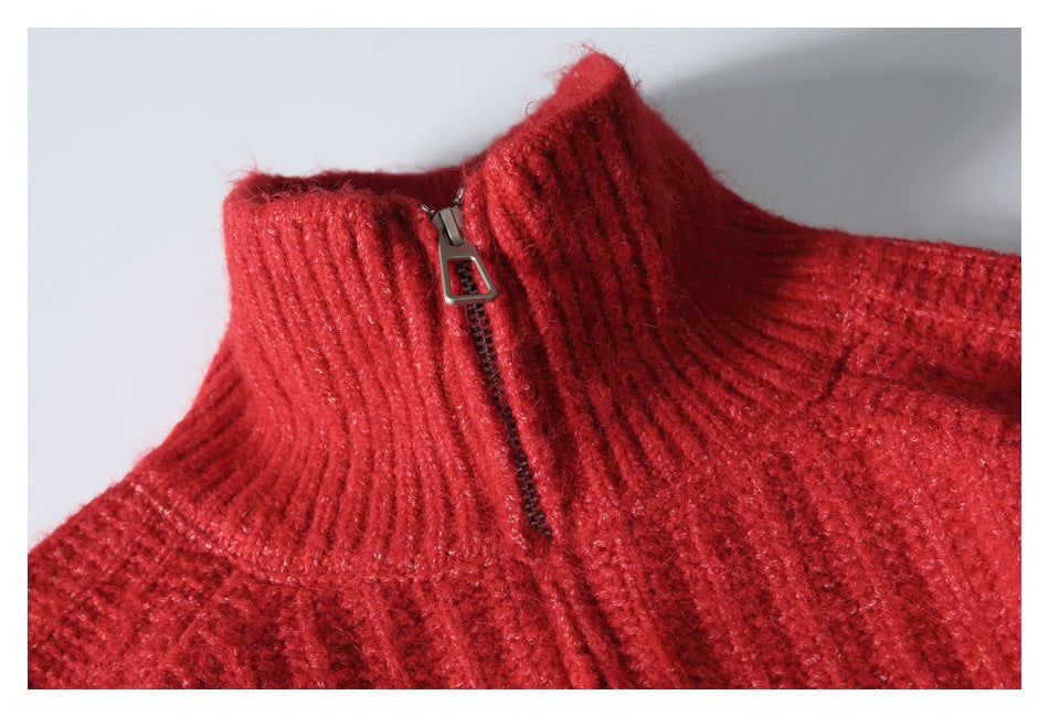 Close-up of the red knit garment's ribbed stand collar and silver zipper.