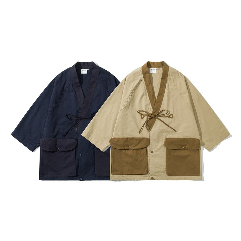 Two loose kimono-style jackets shown from the front: one navy and one beige with brown trim and pockets.