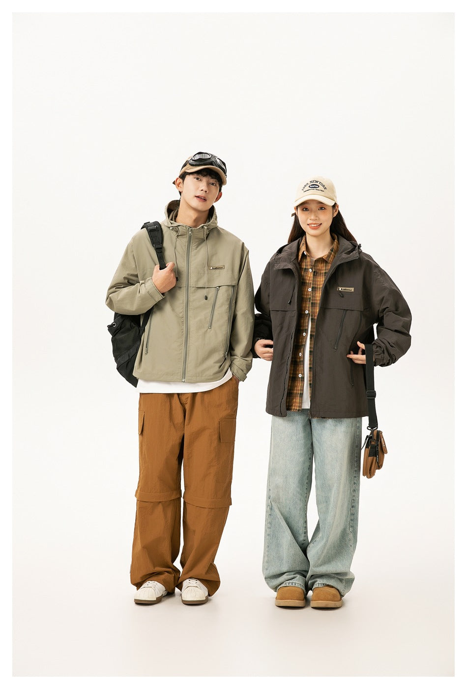 Two models in hooded jackets: a khaki jacket on the man and a dark brown jacket on the woman.