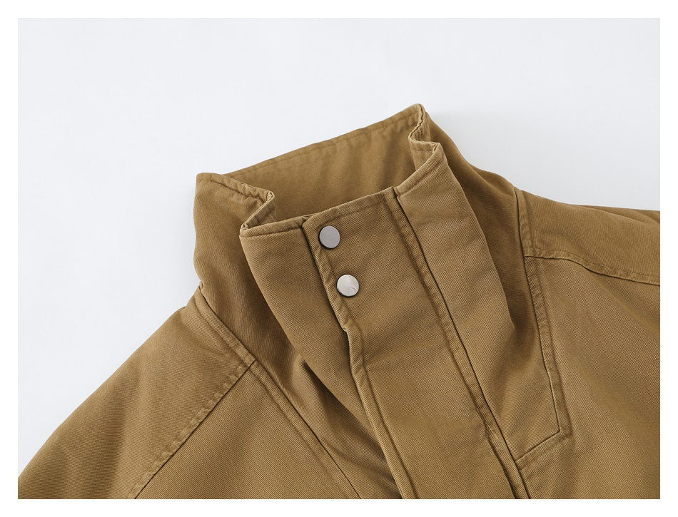 Close-up of the tan jacket collar and snap-fastened front placket.
