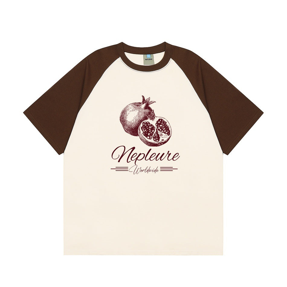 Cream raglan T-shirt with dark brown sleeves and collar and a burgundy pomegranate graphic on the front