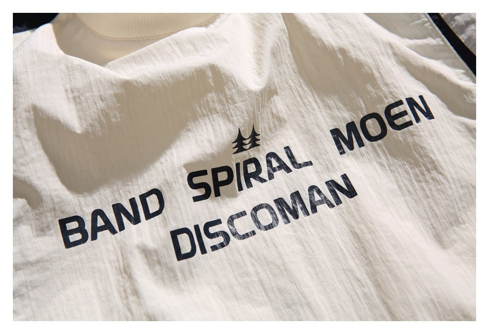Close-up of black printed lettering and a small tree-like motif on the ivory pullover front.