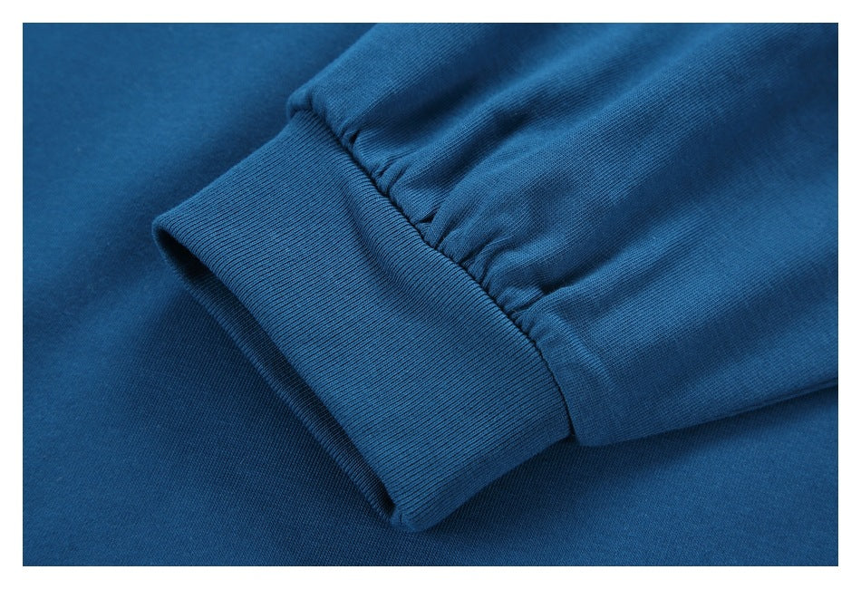 Close-up of a blue garment sleeve ending in a gathered ribbed cuff.
