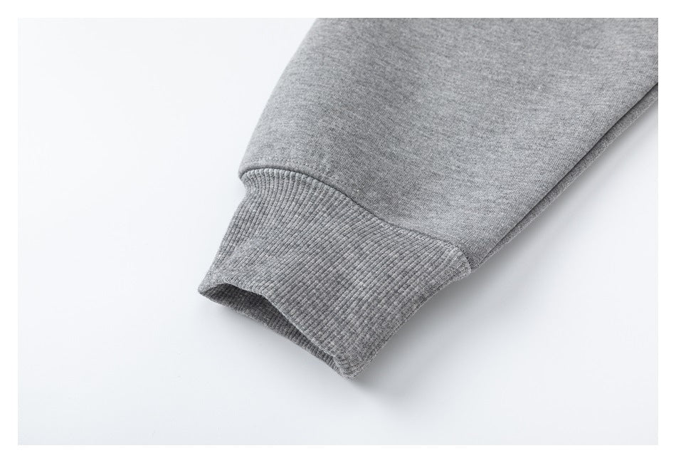 Close-up of a heather gray sleeve ending in a wide ribbed cuff.