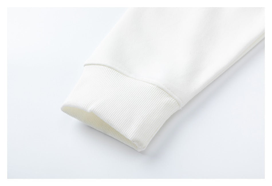 Close-up of a white sweatshirt sleeve ending in a wide ribbed cuff.